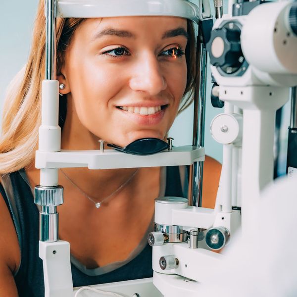 Smiling woman getting an eye exam. 