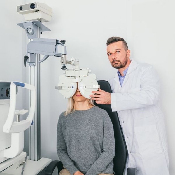 Eye doctor conducting an eye exam on a woman. 