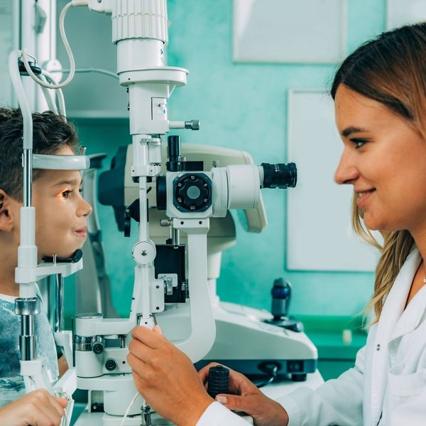eye doctor conducting an exam on a child