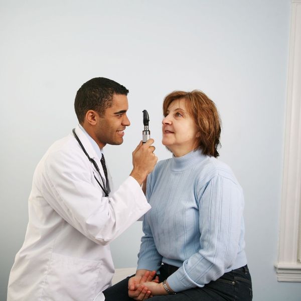 eye doctor examining a woman's eyes