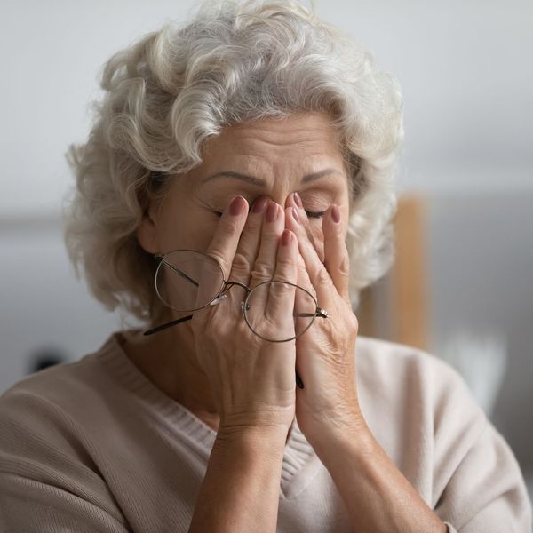 old woman rubbing her eyes