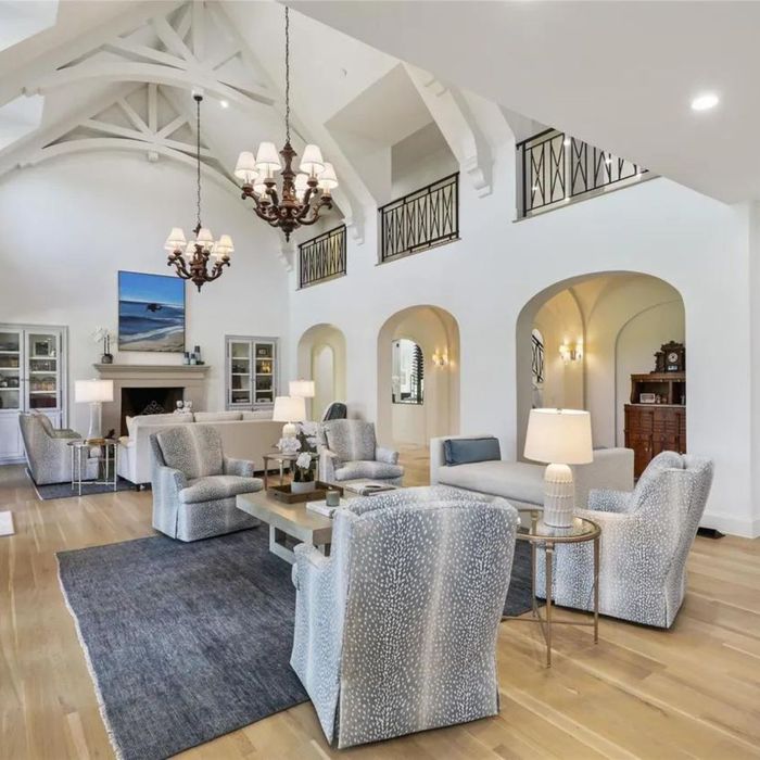 a white living room with spotted furniture