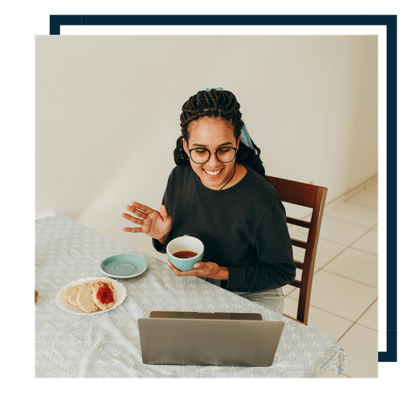 sitting at table with laptop