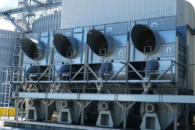 A row of large, electric-powered air coolers with four large fans.