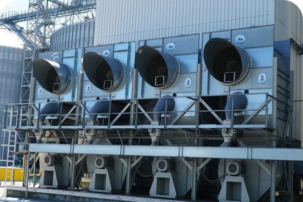 A row of large, electric-powered air coolers with four large fans.