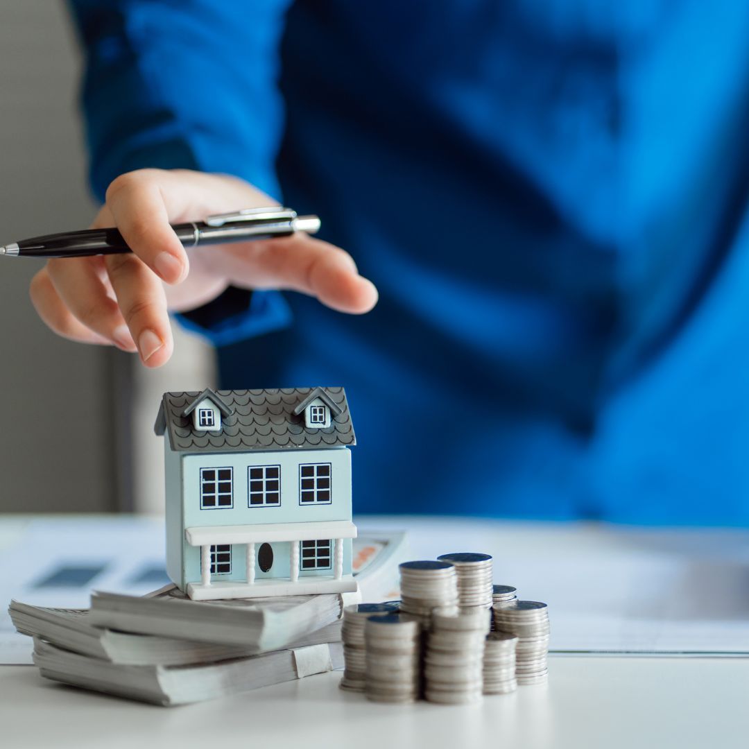 model home and stacks of money