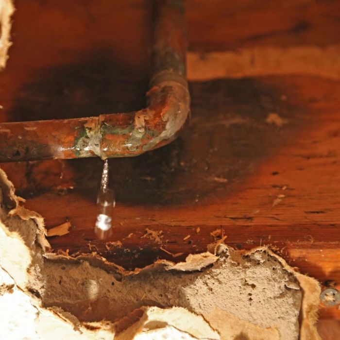 An image of water damaged wood and drywall.