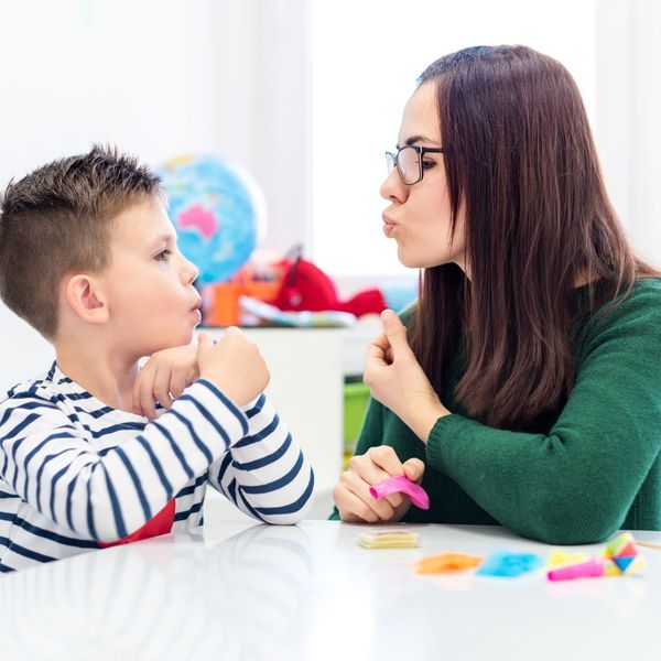 speech pathologist working with boy