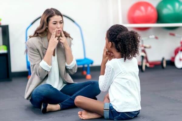 child with speech therapist