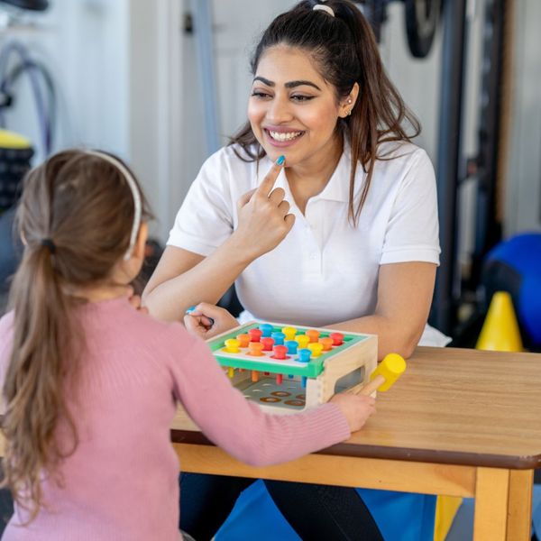 speech pathologist working with girl