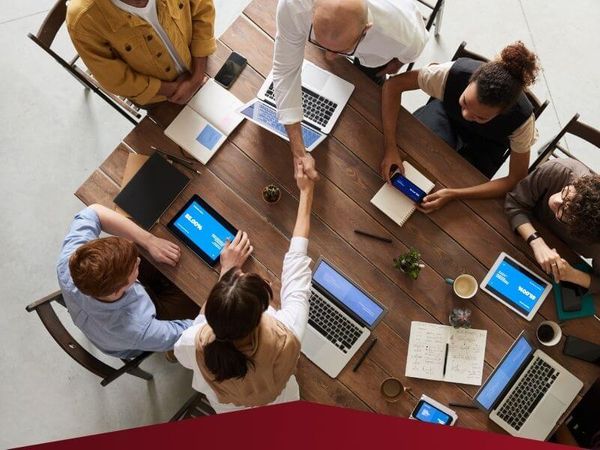business people at a table shaking hands