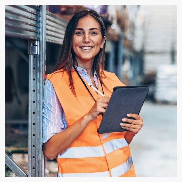 supply worker on tablet smiling