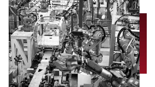robot arms on factory assembly line