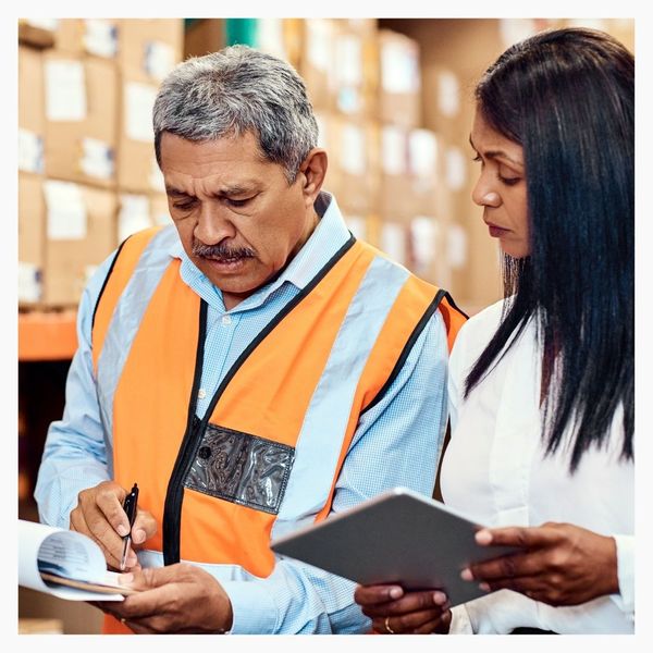 supply workers looking at clipboard