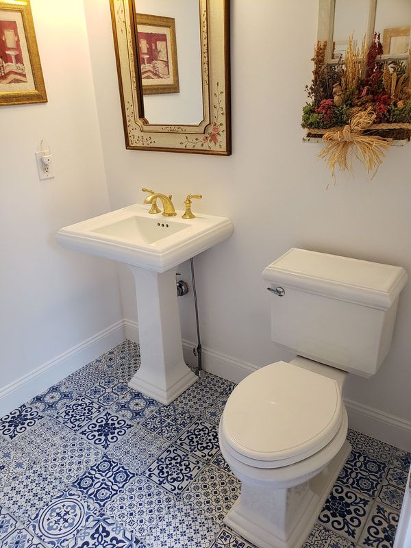 after-new-toilet-and-pedestal-sink-install-white-blue-spanish-tile-floor_1.jpg