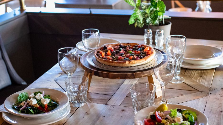 Beautiful table with pizza and salads