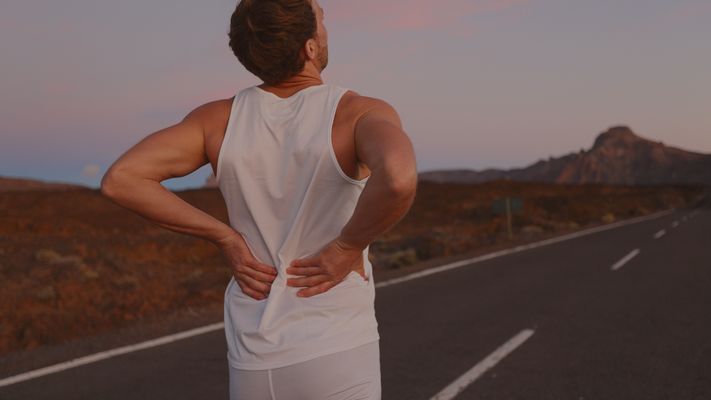 Man holding his lower back