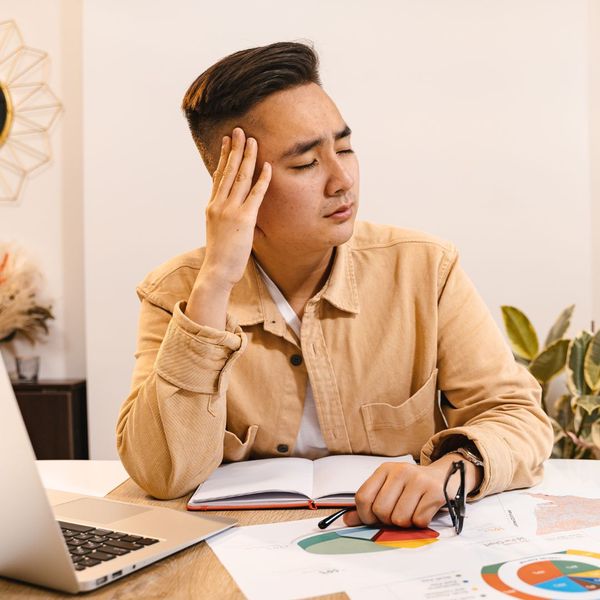 man with headache at computer