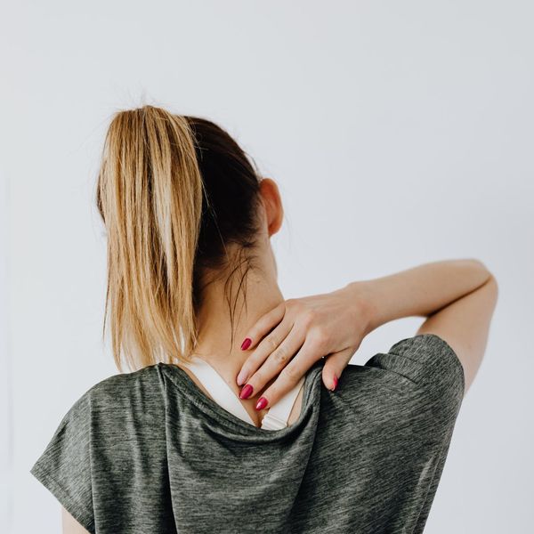 a woman with spine pain The Role of Chiropractic Care.jpg