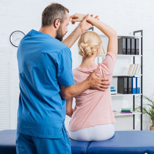 chiropractor adjusting client's back