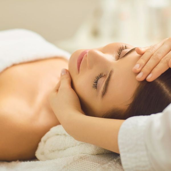 gently maneuvering client's neck/head on massage table