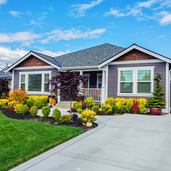 small gray home with a driveway