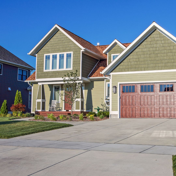 large olive colored house with a garage