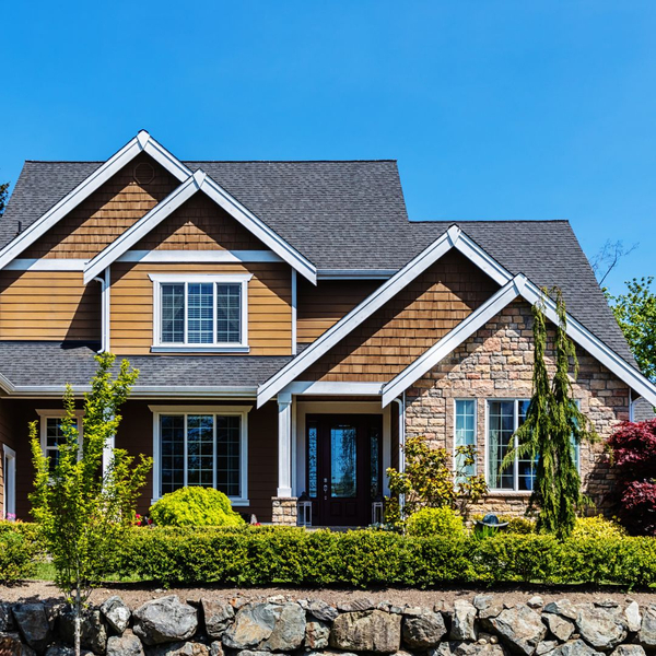 large brown home with a rock scape