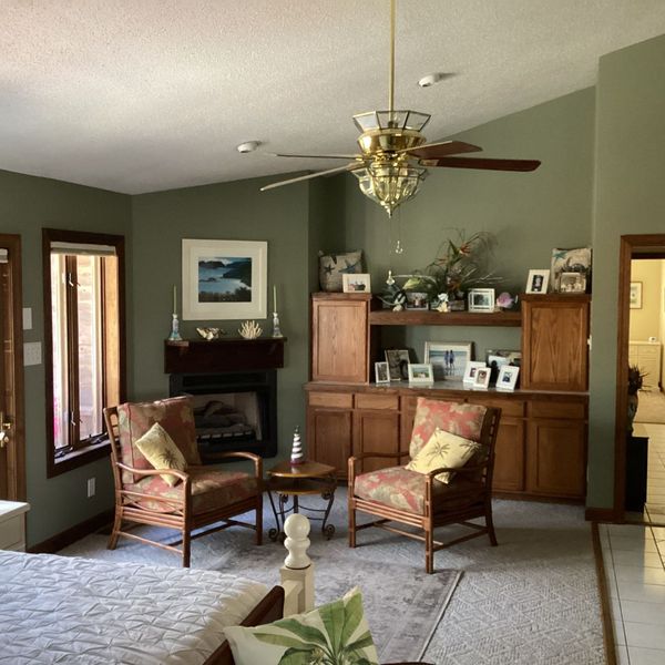 green walls in a living room with wood accents