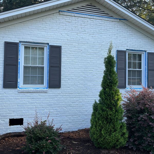 Brick home painted white by L&J Painting