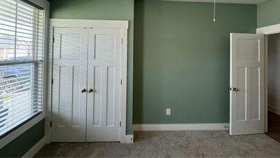 green painted walls with tan carpet