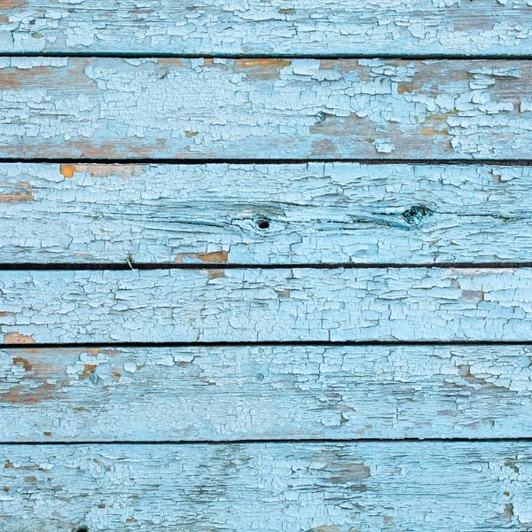 chipping paint on a blue wall