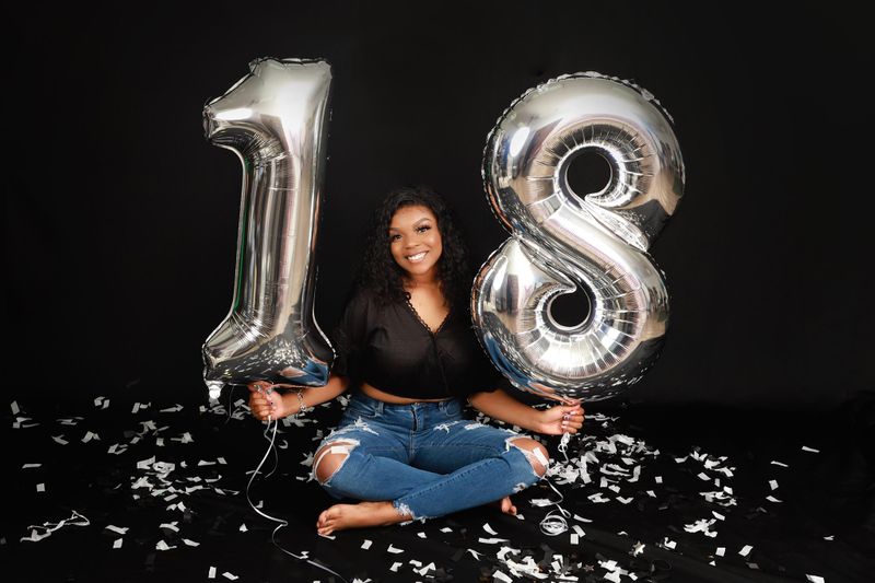 Birthday portrait with number 18 balloons