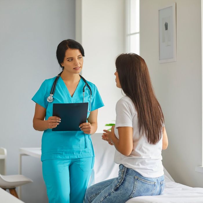 Female patient talking to a female nurse. 