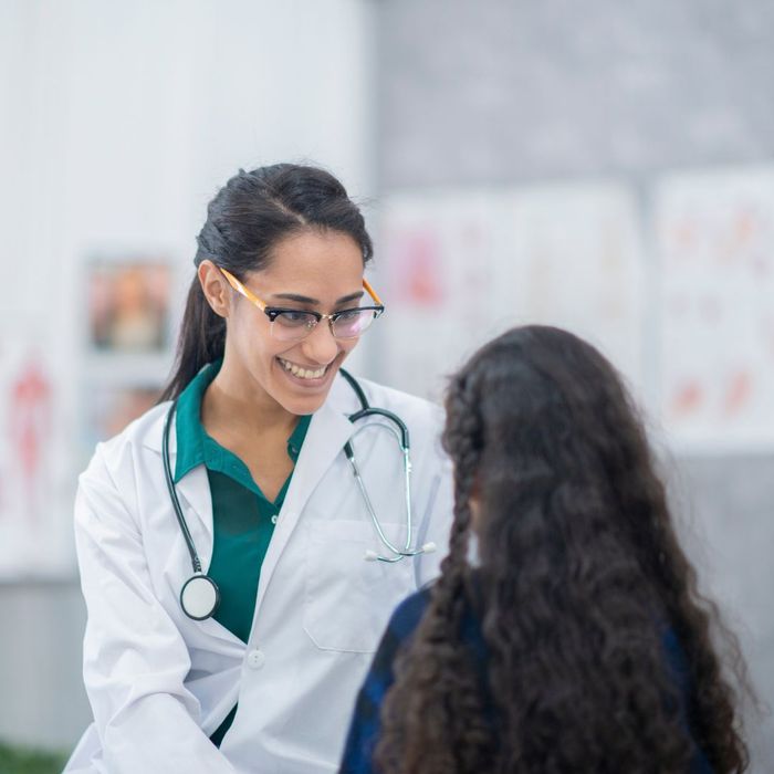 Female doctor talking to a young patient. 
