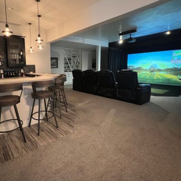Virtual golf course in front of a home bar