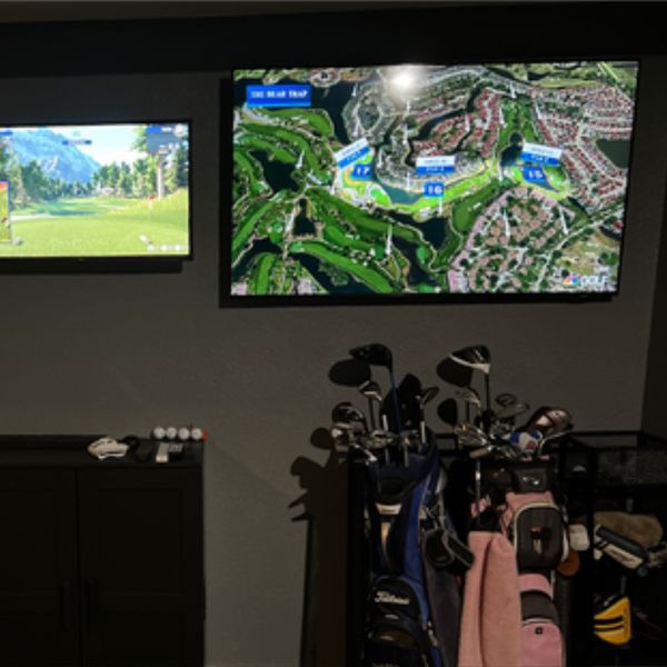 Golf club bags under a screen mapping a golf course