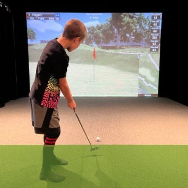kid using golf simulation