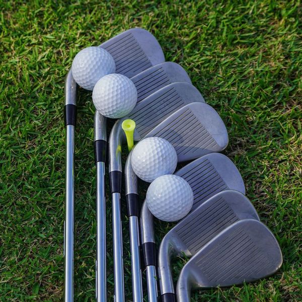 several golf clubs and balls