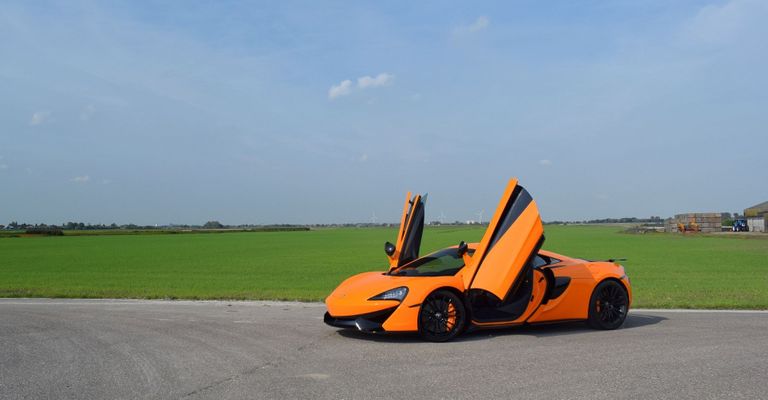 orange McLaren with its doors open