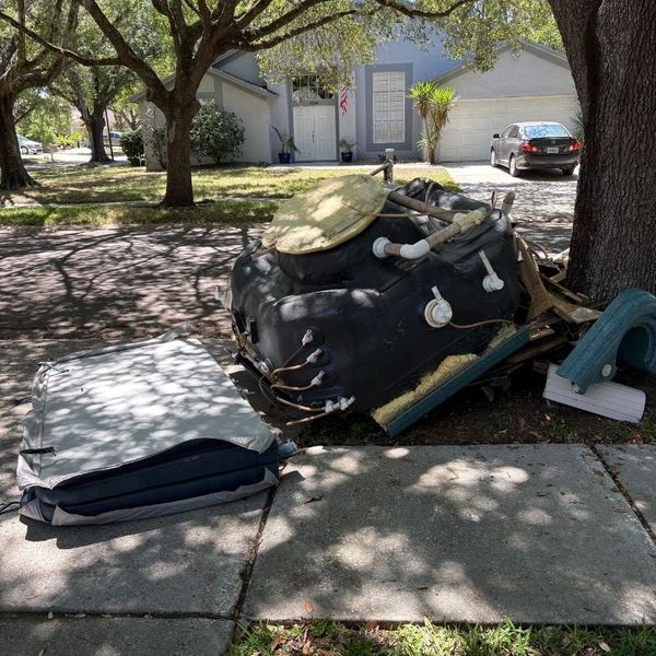 Junk out on the corner of a street, ready to be hauled away.