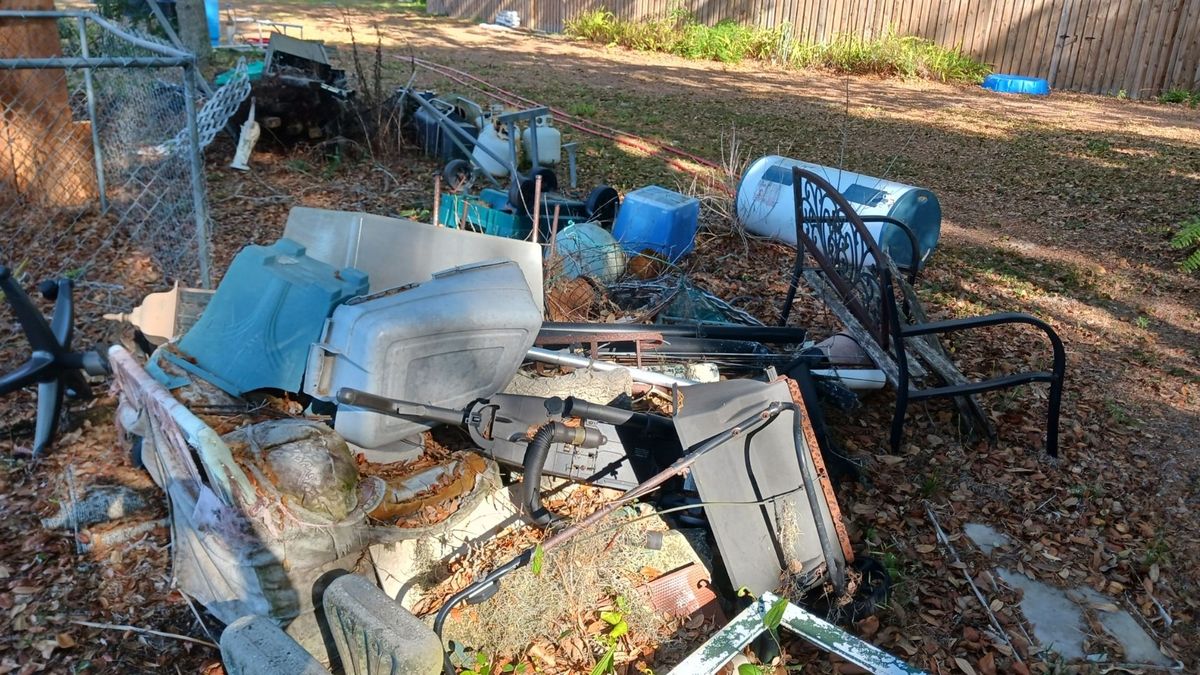 A pile of junk and debris in a home's yard.