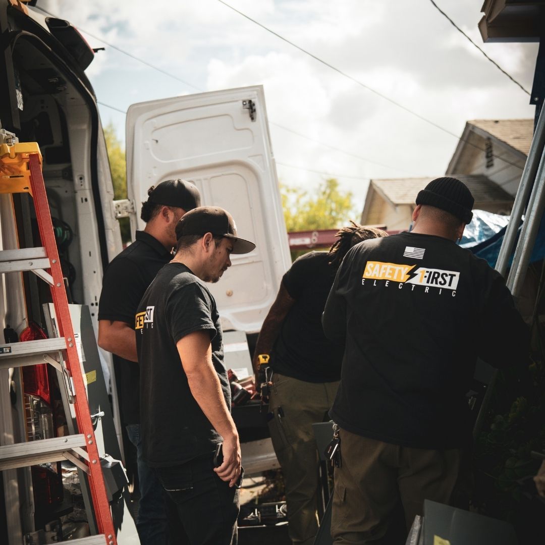 electrician carrying equipment to home