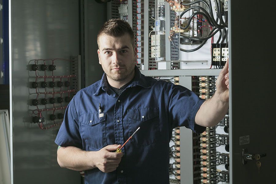 Electrician looking at electric panel