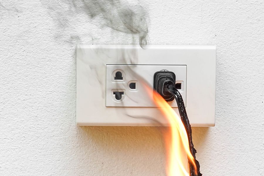 An electrical fire at a power outlet