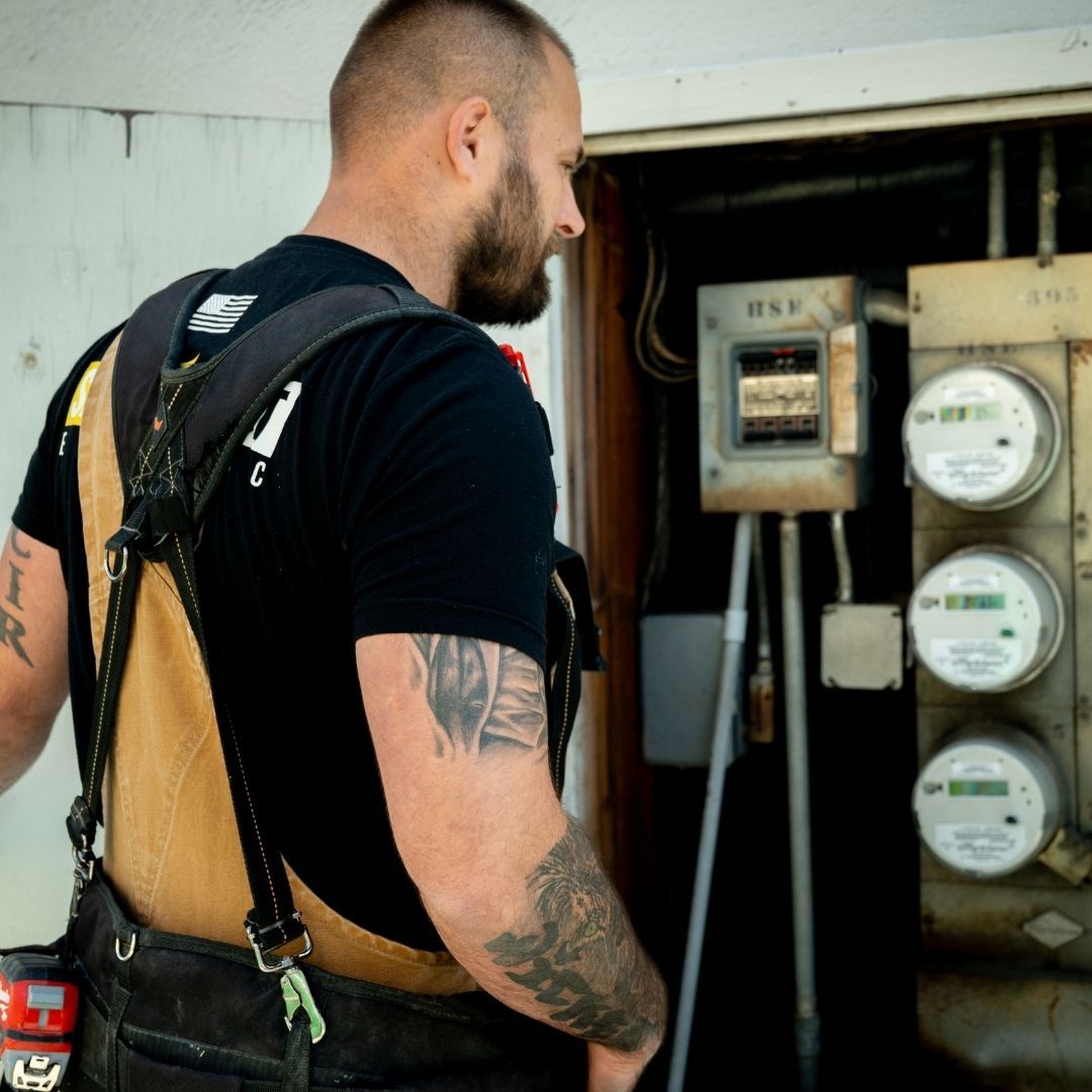 safety first electrician inspecting panel
