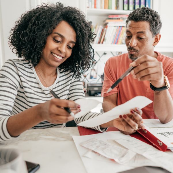 couple doing taxes smiling