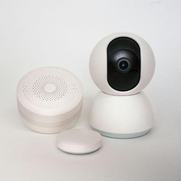 A security camera next to a speaker