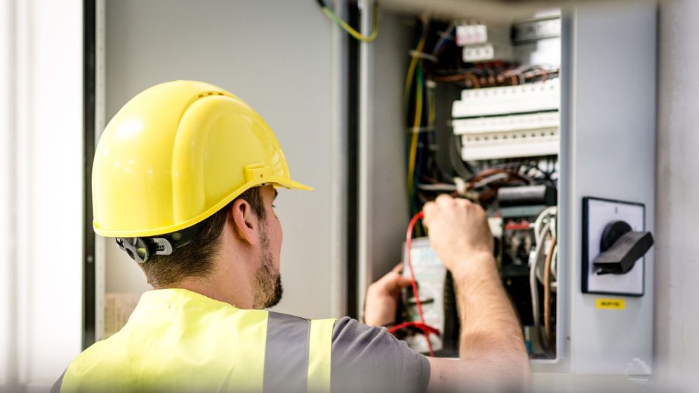 electrician working on electrical panel