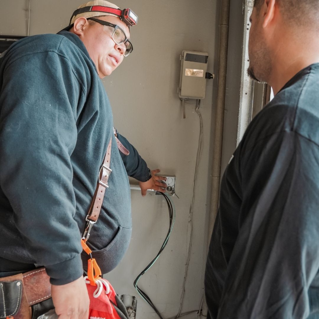 electricians discussing outlet work